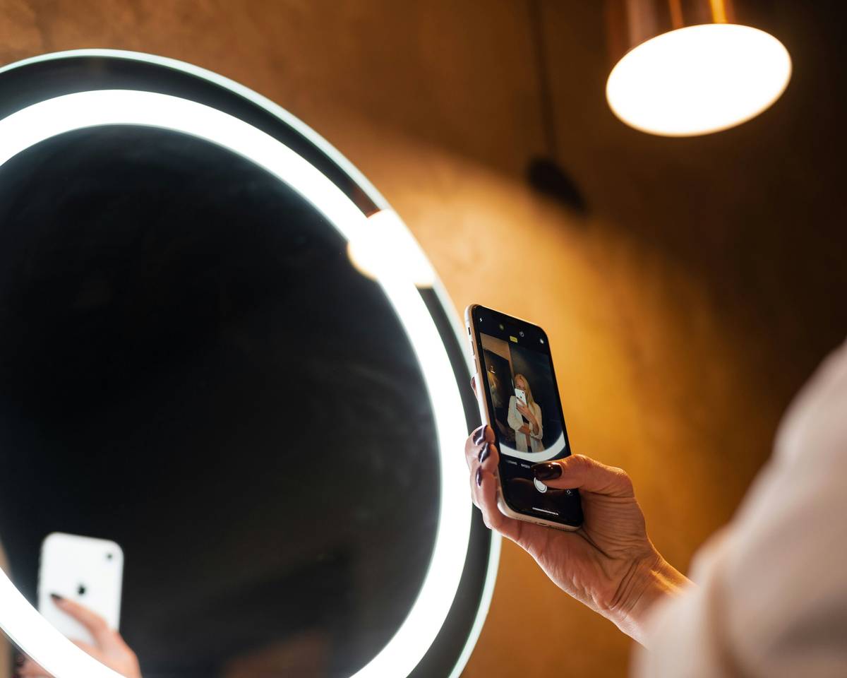 what is smart mirror: a modern bedroom with a wall-mounted smart mirror displaying weather and calendar
